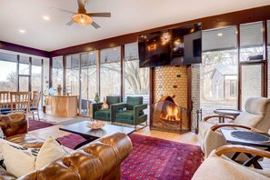 Cozy living area with a fireplace, comfortable seating, and a flat-screen TV.
