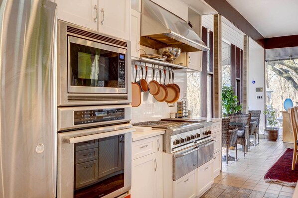 Enjoy cooking in the well-equipped kitchen with a microwave, oven, and stove, and dine in the adjacent seating area.
