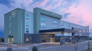 A modern hotel with a flat facade, large windows, and a covered entrance. - SpringHill Suites Tucson at The Bridges (Tucson)