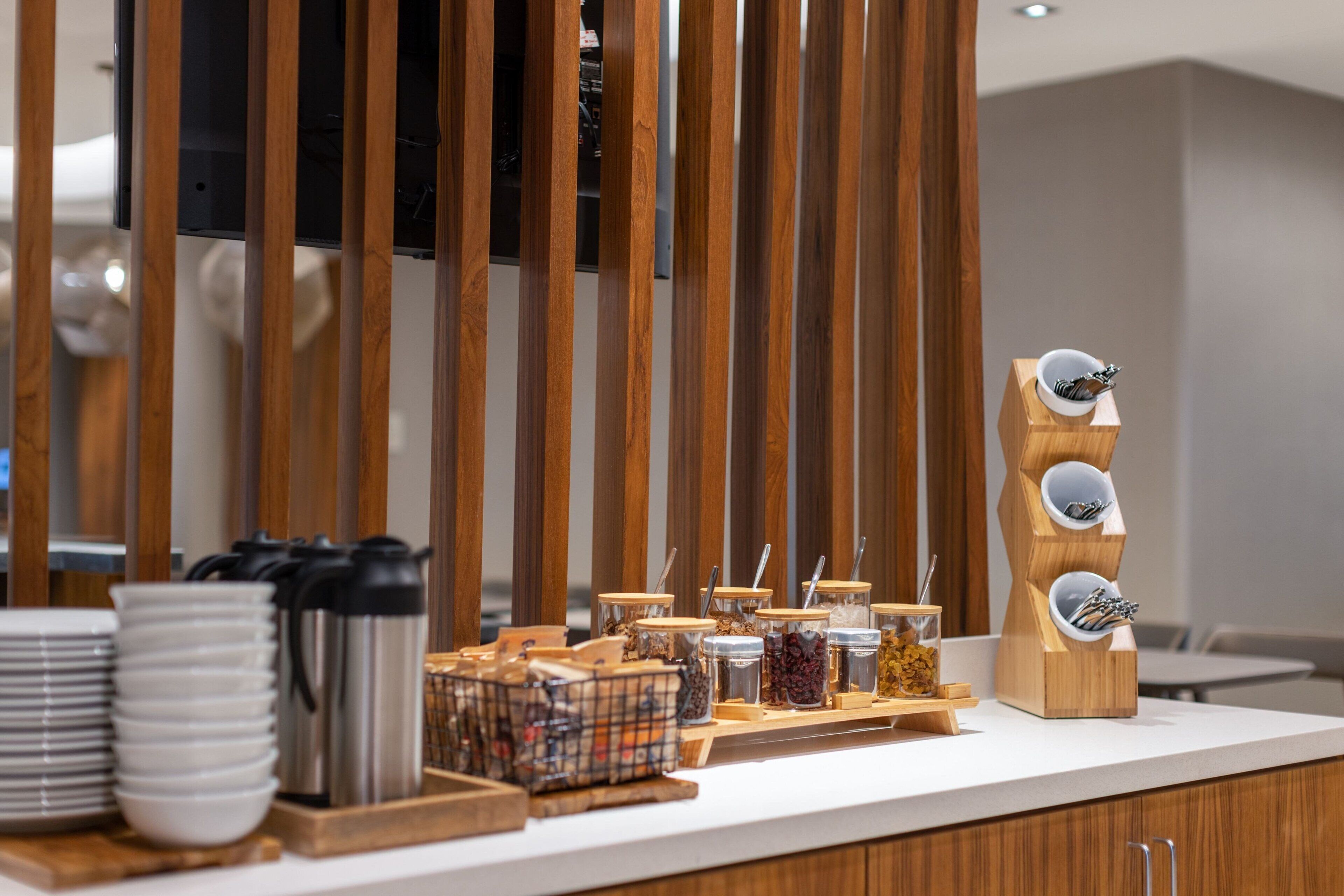 A breakfast buffet setup with various food items and utensils.
