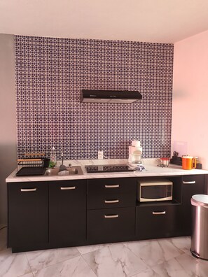 Fridge, microwave, coffee/tea maker, cookware/dishes/utensils