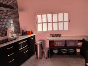 Fridge, microwave, coffee/tea maker, cookware/dishes/utensils