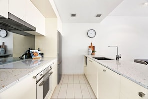 Three Bedroom Apartment With Parking | Private kitchen | Full-size fridge, microwave, oven, stovetop