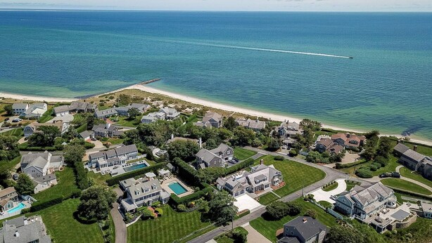 An aerial view of a coastal residential area with houses, a beach, and a clear blue ocean. - Luxurious Estate, Private Heated pool! (West Harwich)