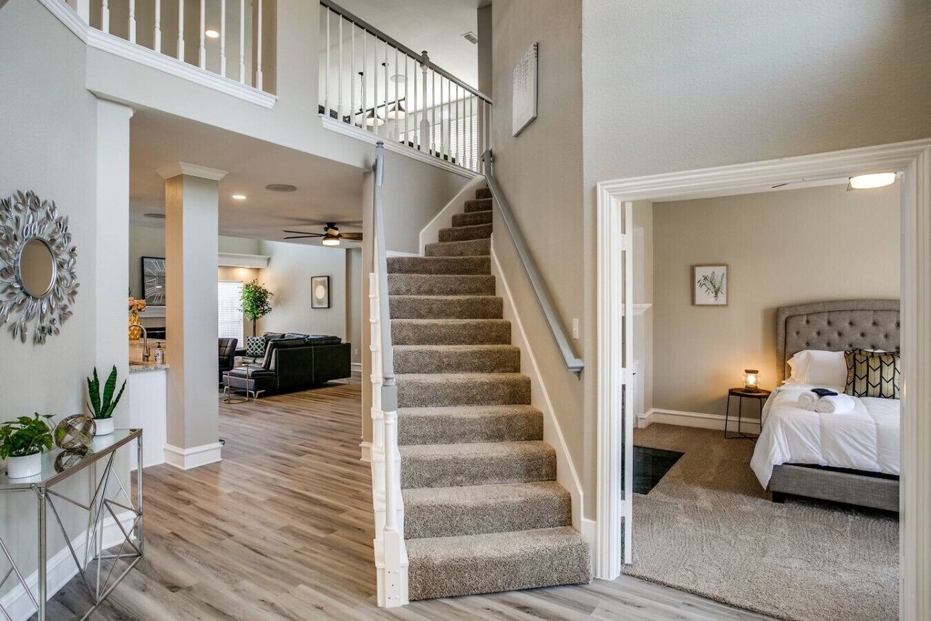 A spacious living area with a staircase leading to a bedroom.