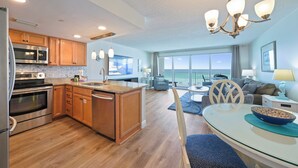 A modern kitchen with wooden cabinets, stainless steel appliances, and a central island. - Amazing Gulf Front Views at Cabana Club 307 (Destin)