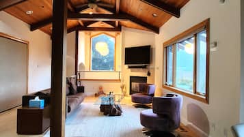 Exclusive House | Living area | 65-inch flat-screen TV with cable channels, TV, fireplace