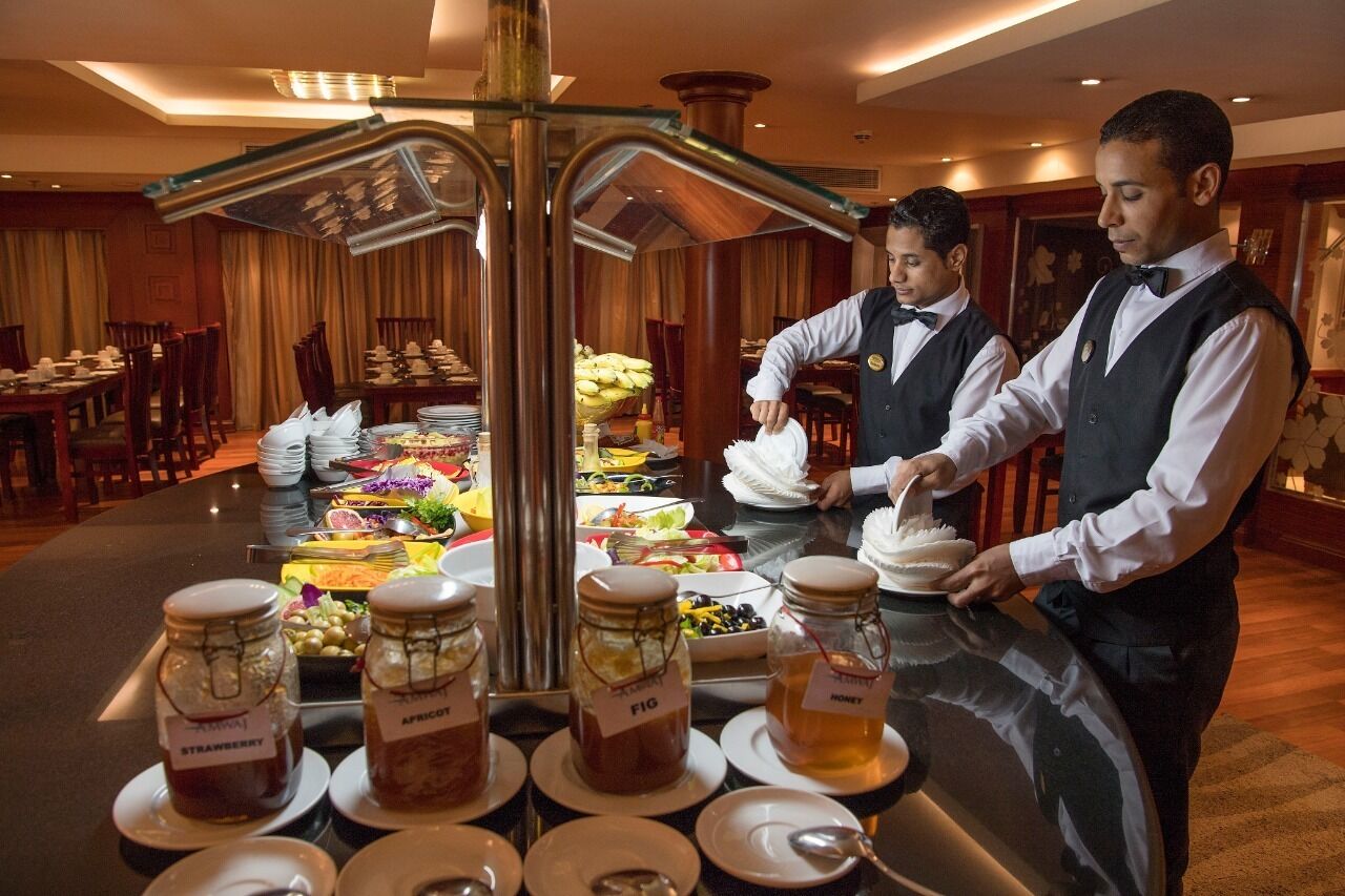 A buffet setup with various food items and condiments.