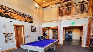 A pool table in a room with wooden ceilings and a mural on the wall. - Perfect petite over 400 sq ft (Breckenridge)