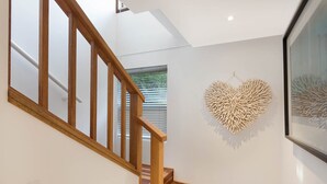 A staircase with wooden railings leading to a landing. - Gillmith - Sleeping up to 16 people (Pambula Beach)