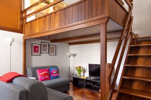 TV - GuestHost - Spacious two-room apartment with kitchen for 5 persons with one bedroom, living room with sofa bed and a loft (overlooking the rooms below) with a bed and office area. The kitchen/dining room is separate. In total 65 sqm in old Milan building (Milan)