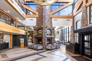 A spacious lobby with a stone fireplace, seating area, and a reception desk. - Westgate 4404AB (Park City)