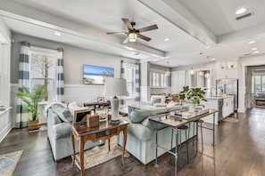 A spacious living room with a sofa, coffee table, and a TV.