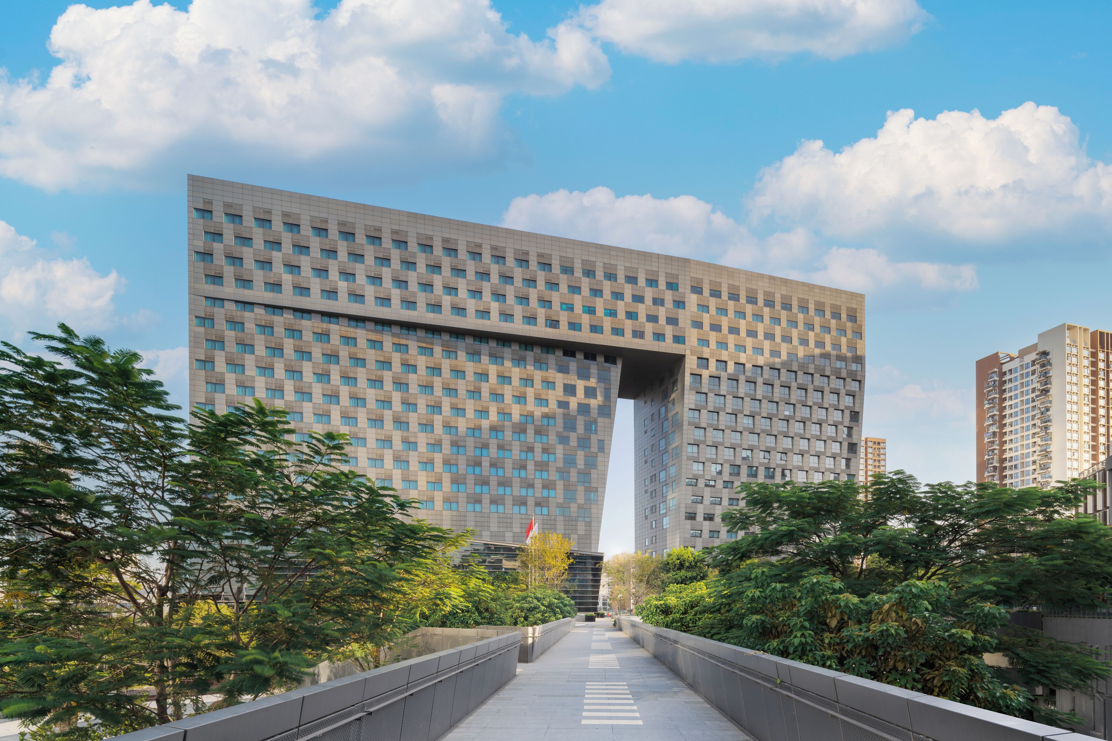 A modern building with a grid-like facade and a central entrance.