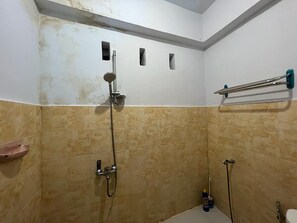 A small, tiled shower area with a handheld showerhead, a towel rack, and a soap dish. - Hotel O Surya HotelNearTaman Anggrek Pkk Watansoppeng (Watansoppeng)