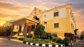 A hotel with a prominent entrance, a statue, and a well-maintained garden. - Palette Ancol Near Dufan Formerly BI Executive (Jakarta)
