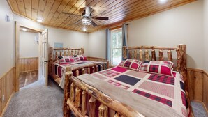 A bedroom with two wooden beds, a ceiling fan, and a window with curtains. - PA Grand Canyon, Mountain View, Pine Creek (Gaines)