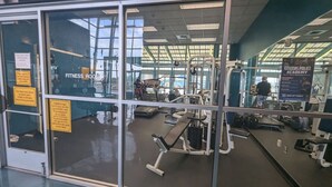 A fitness room with exercise equipment, a mirrored wall, and a sign for the Citizens Police Academy. - Alluring #A 1 Queen & courtyard by Fremont Str (Las Vegas)