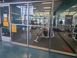 A fitness room with exercise equipment, a mirrored wall, and a sign for the Citizens Police Academy. - Alluring #A 1 Queen & courtyard by Fremont Str (Las Vegas)