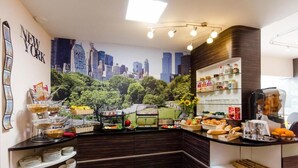 A breakfast bar with a cityscape mural, shelves with condiments, and a coffee machine. - Hotel La Roseraie  (Wemmel)