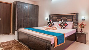 A modern bedroom with a large bed, a wardrobe, a nightstand, and a decorative vase. - The Mountains Retreat (Krishangarh)