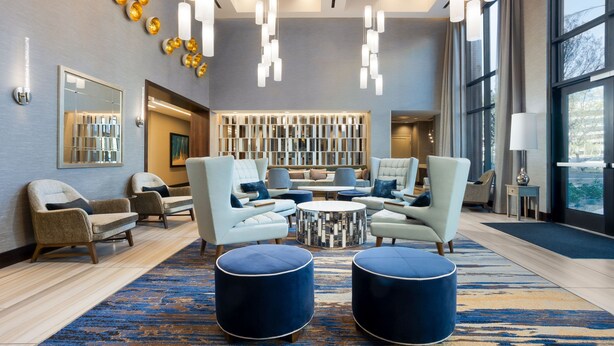 A modern lobby with seating areas, a coffee table, and a large window offering a view. - Residence Inn by Marriott Anaheim Brea (Brea)
