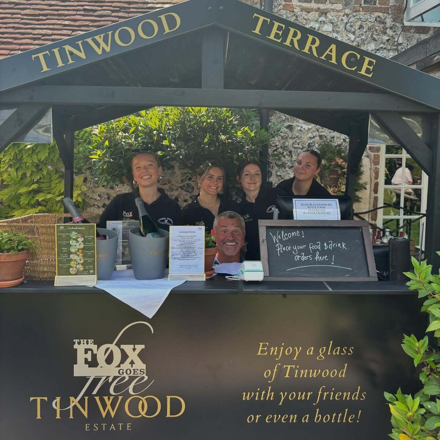 A terrace at The Fox Goes Tinwood Estate with a sign welcoming customers to place food and drink orders.