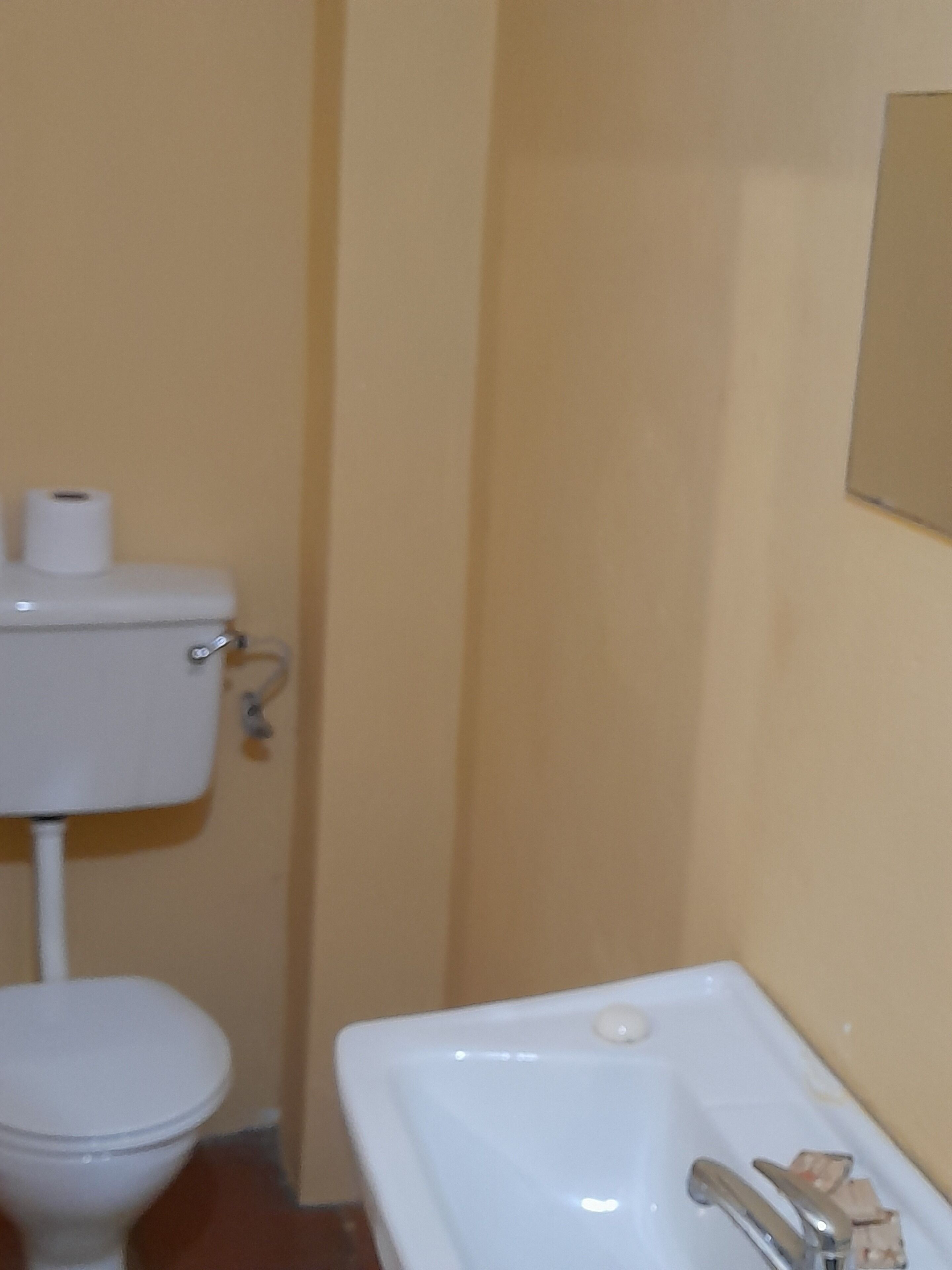 A small bathroom with a toilet and a sink.