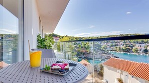 Enjoy a meal on the balcony with a scenic view of the coastal town.