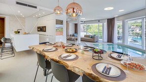 Enjoy meals in the spacious kitchen and dining area, complete with a large table and modern chairs.