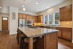 Enjoy cooking in this well-equipped kitchen with a large island and stainless steel appliances.