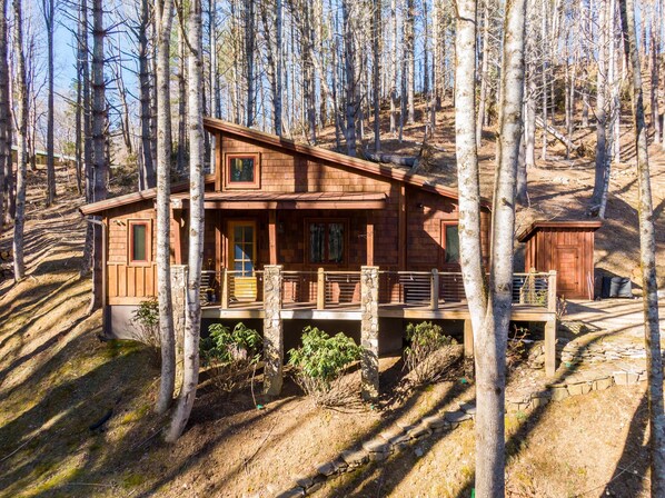 Guests can enjoy a sheltered front porch with a central door flanked by windows.