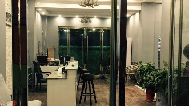 A modern office space with a desk, chairs, and a small kitchenette area. - 99 Express Hotel (Lixin)