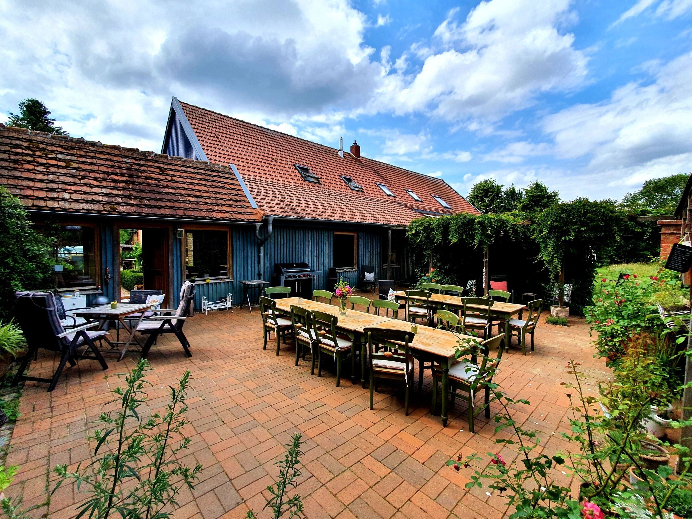 A patio area with outdoor seating and a barbecue grill.