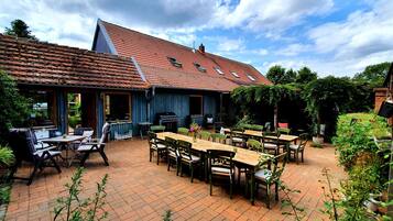 A patio area with outdoor seating and a barbecue grill.