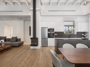 Cozy living space with a fireplace, oven, and dining area.