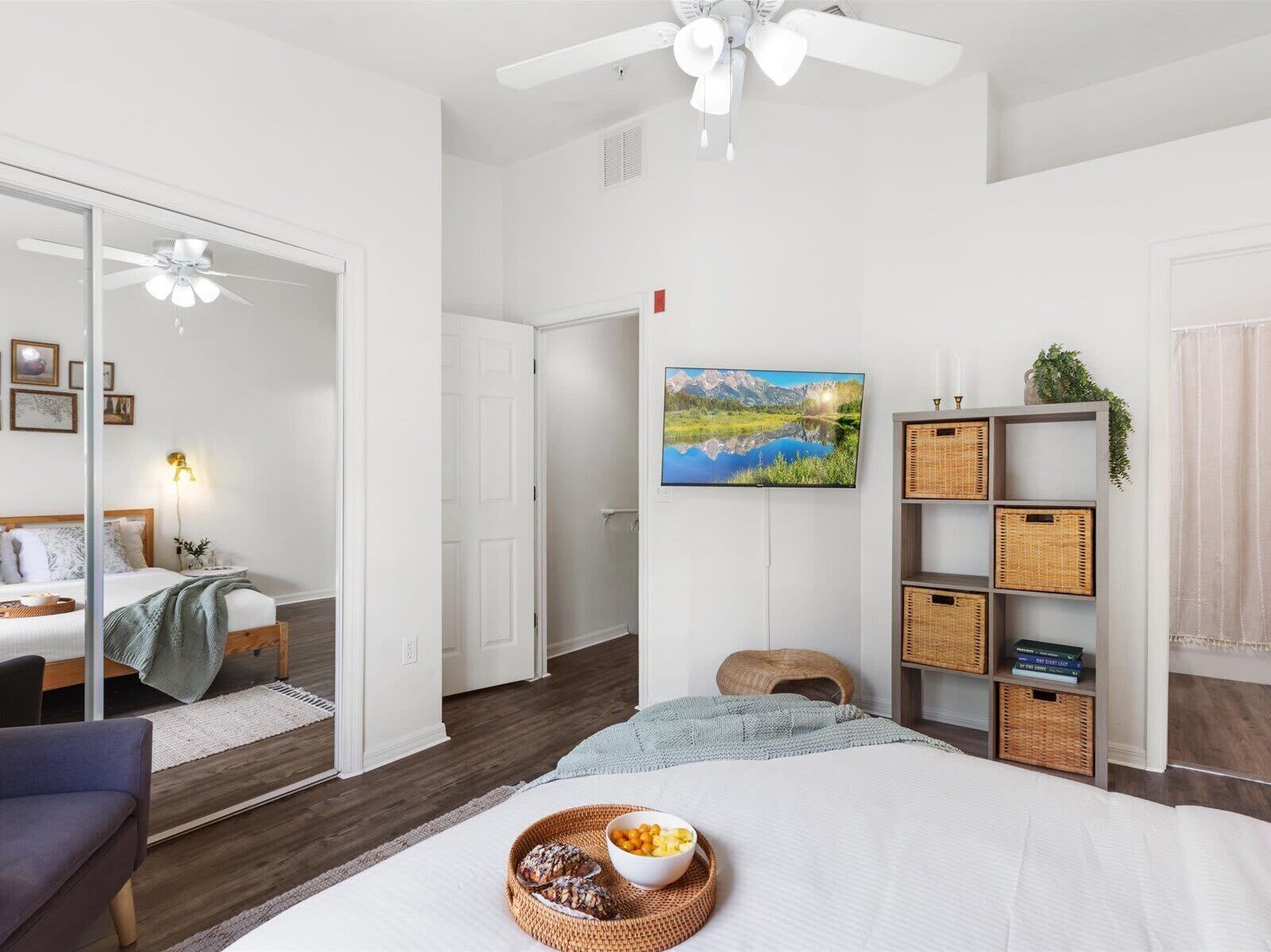 Light-filled bedroom with plush bedding and TV—unwind in privacy and style.