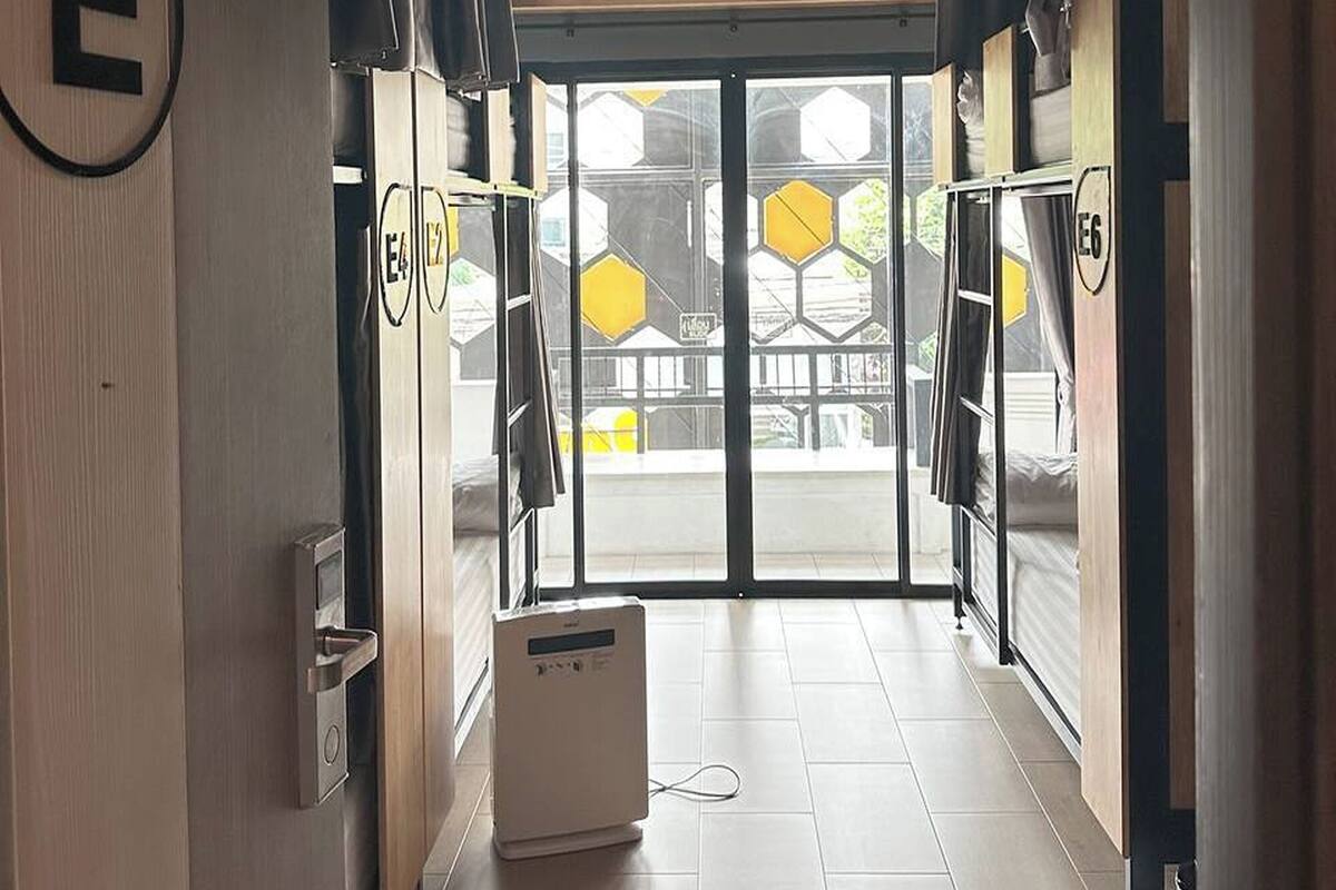 A hallway with a door marked 'E6' leading to a room with a hexagonal window design.