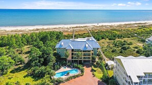 A hotel with a pool, surrounded by greenery and a beach view. - August 2026 Rate Drop! Serendipity by the Sea - 3BR/2BA (Port St. Joe)