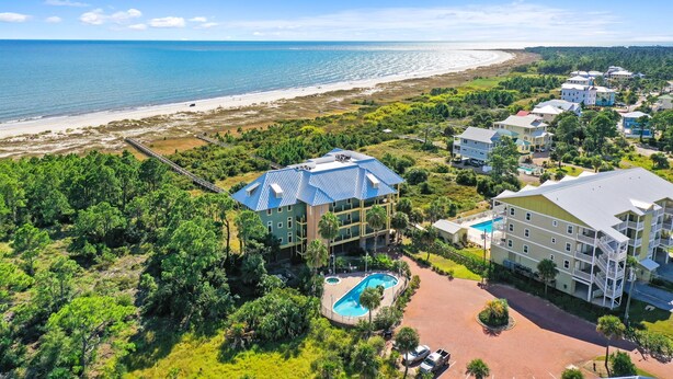 A resort with a pool, beachfront view, and multiple buildings. - August 2026 Rate Drop! Serendipity by the Sea - 3BR/2BA (Port St. Joe)