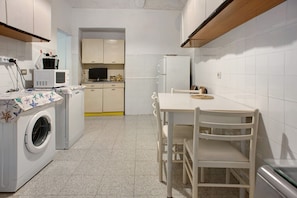 A compact kitchen with a washing machine, microwave, and refrigerator. - Apartment 'Casa Paola' with Private Terrace and Wi-Fi (levanto)