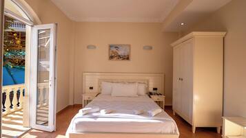 Un dormitorio con cama, mesitas de noche, un armario y un cuadro en la pared.