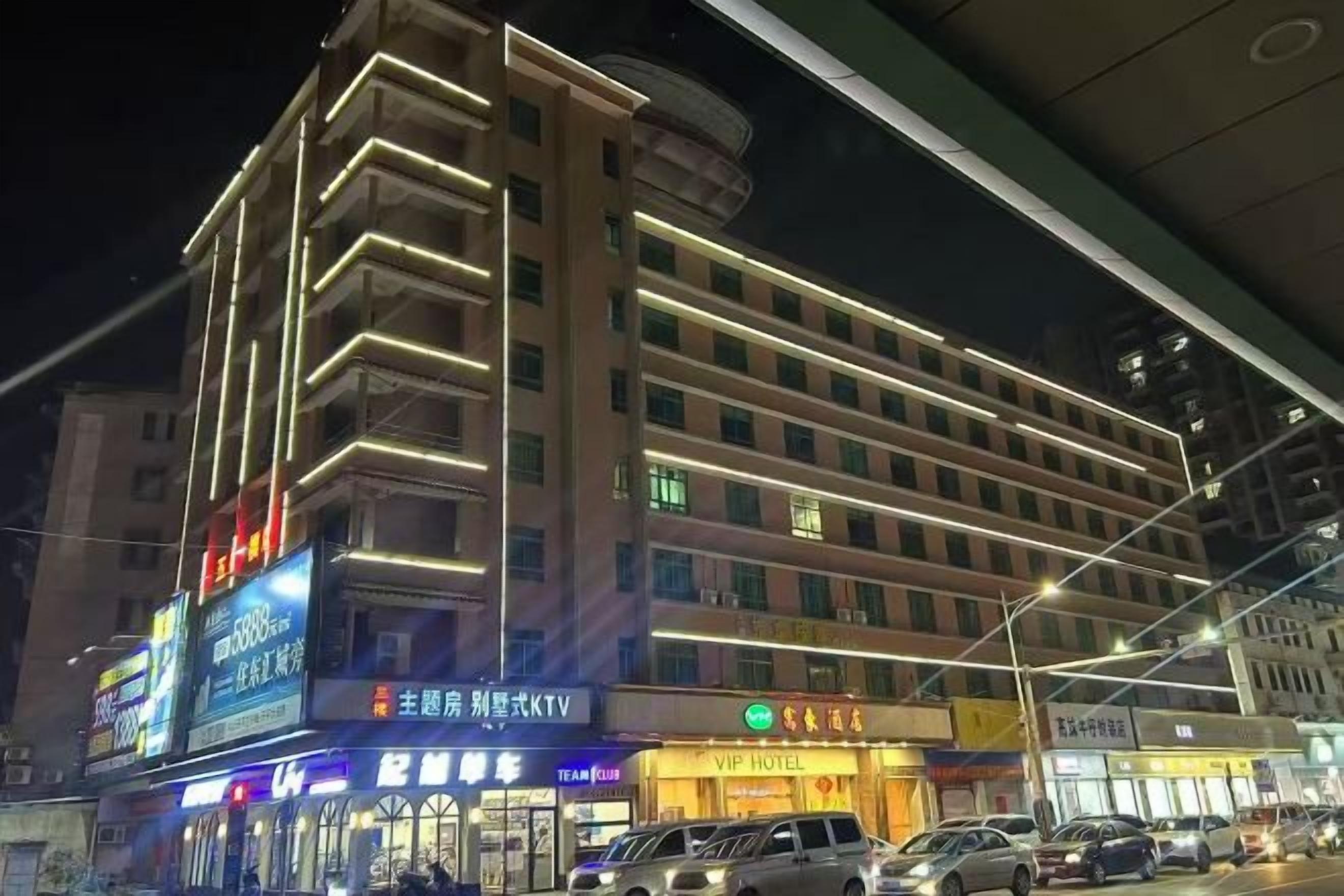 A multi-story hotel with a modern design, featuring a prominent entrance and signage for the VIP Hotel.