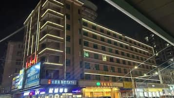 A multi-story hotel with a modern design, featuring a prominent entrance and signage for the VIP Hotel.