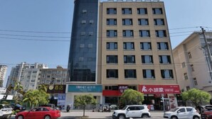 A multi-story building with a modern facade, featuring a mix of glass and concrete. - Baihe Boutique Hotel (Yueqing Beibaixiang Store) (Yueqing)