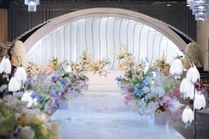 An arched entrance with floral decorations and hanging ornaments. - Sceneway Hotel (Quanjiao)