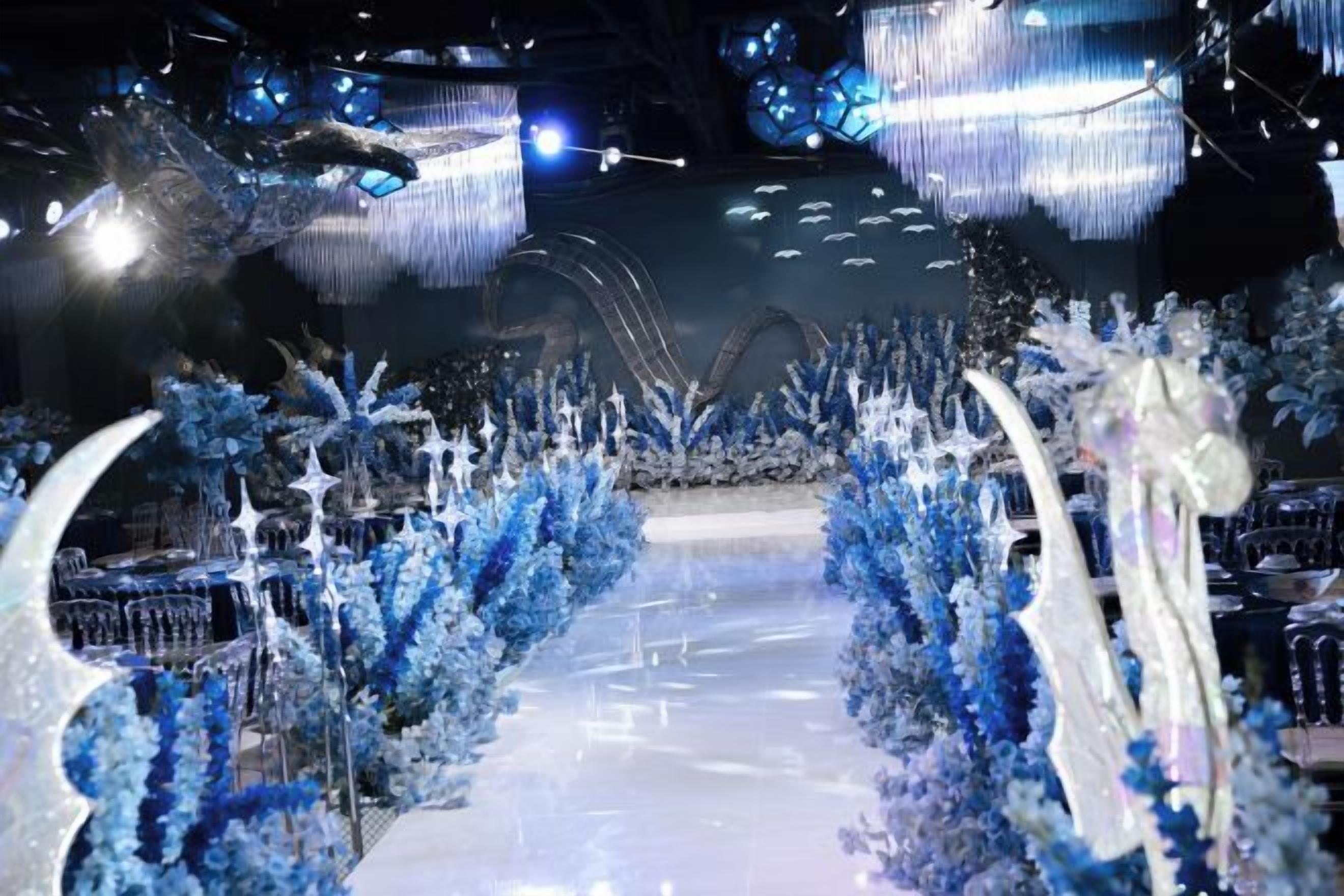 A corridor with a reflective floor and blue decorative elements.