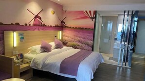 A hotel room with a bed, a nightstand, a glass door, and a mural of windmills and lavender fields. - Yiru Hotel (Xinfeng) (Xinfeng)