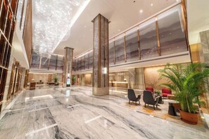 A spacious lobby with marble flooring, seating areas, and large windows offering city views. - Fuqing Yonghong Hotspring Resort (Fuqing)