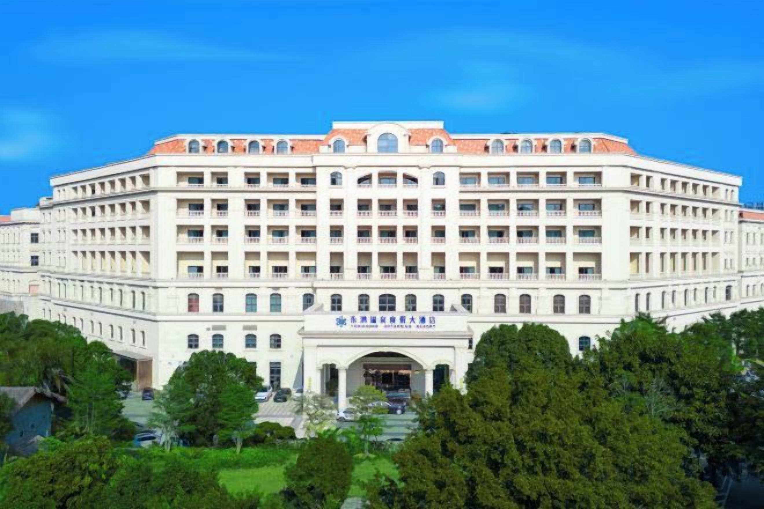 A large, multi-story building with a symmetrical facade, numerous windows, and a central entrance.
